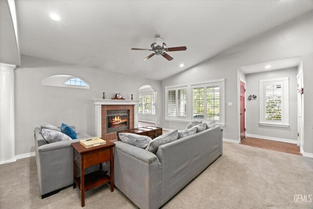 501 Reed St, Bakersfield, CA 93314 - carpeted living area featuring vaulted ceiling, ceiling fan, a fireplace, recessed lighting, and baseboards