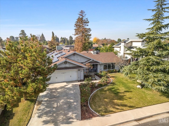 501 Reed St, Bakersfield, CA 93314 - view of front of home featuring driveway, a front lawn, a garage, cooling unit, and solar panels