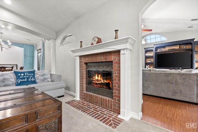 501 Reed St, Bakersfield, CA 93314 - living area featuring a brick fireplace, lofted ceiling, carpet floors, a chandelier, and baseboards