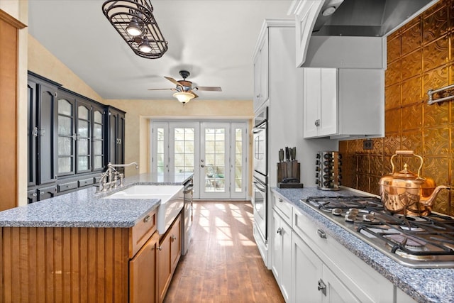 501 Reed St, Bakersfield, CA 93314 - kitchen featuring appliances with stainless steel finishes, a sink, wall chimney exhaust hood, tasteful backsplash, and ceiling fan