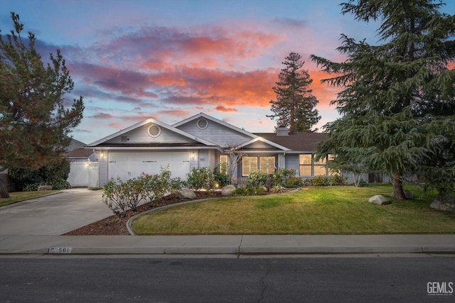 501 Reed St, Bakersfield, CA 93314 - ranch-style house featuring driveway, a lawn, a garage, and a chimney