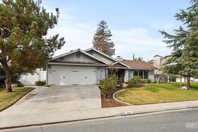 501 Reed St, Bakersfield, CA 93314 - single story home featuring an attached garage, concrete driveway, and a chimney