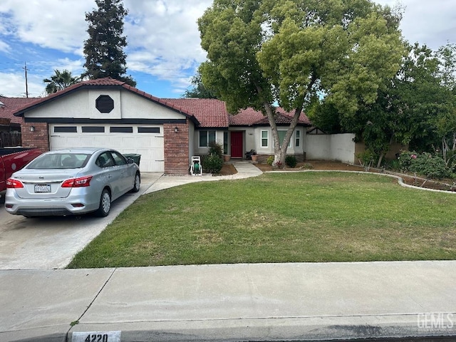 4220 Northwind Dr, Bakersfield, CA 93313 - ranch-style home with concrete driveway, a tiled roof, an attached garage, stucco siding, and a front lawn