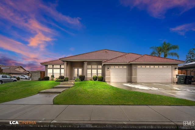 view of front of home with a lawn and a garage