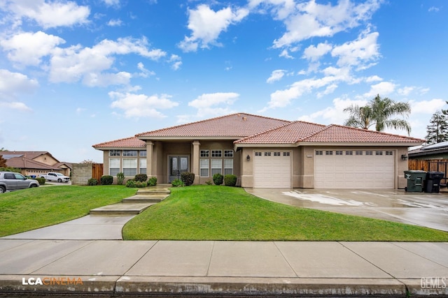 mediterranean / spanish home featuring a front lawn and a garage