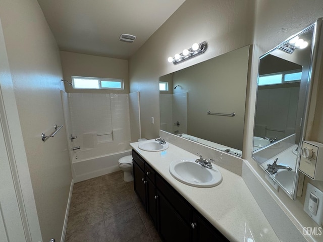 bathroom with a sink, tile patterned flooring, toilet, and  shower combination