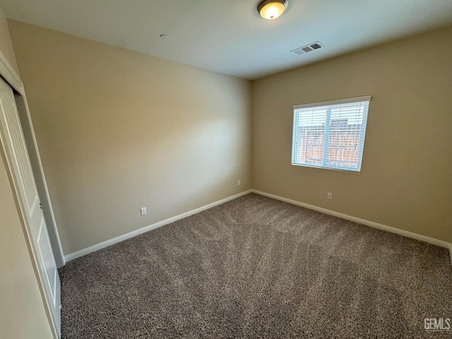unfurnished room with carpet flooring, baseboards, and visible vents