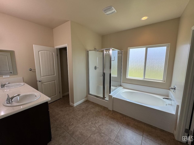 full bathroom featuring a sink, tile patterned flooring, a shower stall, and a garden tub