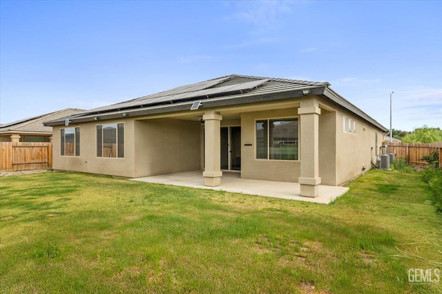 11001 Arundel Way, Bakersfield, CA 93311 - back of house featuring stucco siding, a patio area, roof mounted solar panels, and central AC