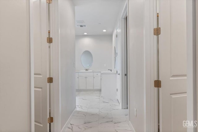 11001 Arundel Way, Bakersfield, CA 93311 - corridor with light marble finish floors, baseboards, recessed lighting, and a sink