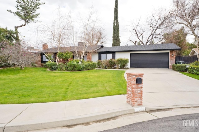 ranch-style home with an attached garage, a front lawn, concrete driveway, and brick siding