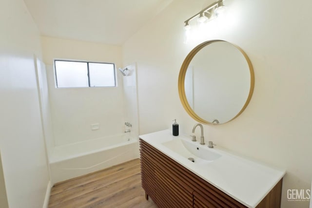 bathroom with shower / bathing tub combination, wood finished floors, and vanity