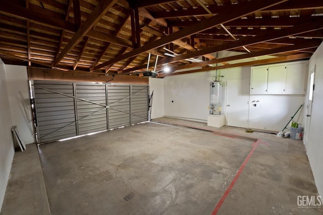 garage with water heater and a garage door opener