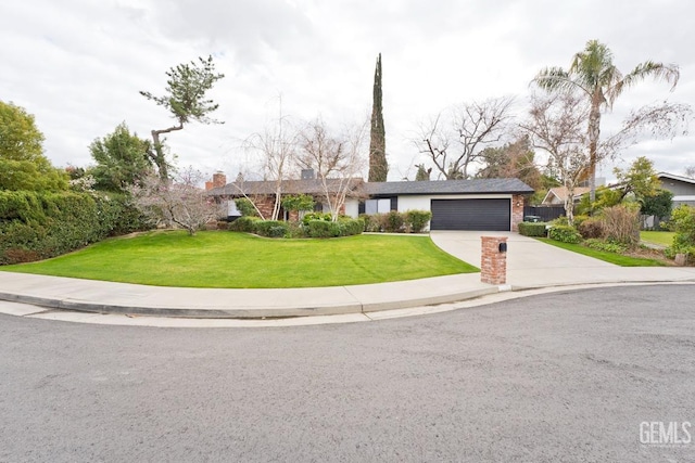 view of front facade featuring a garage, concrete driveway, a front lawn, and brick siding