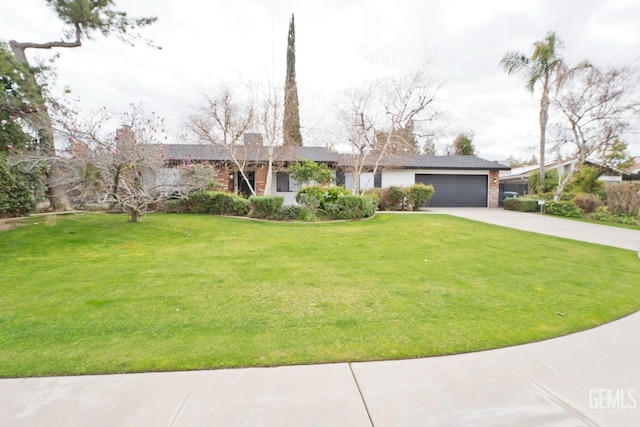 view of front facade featuring a garage, concrete driveway, and a front yard