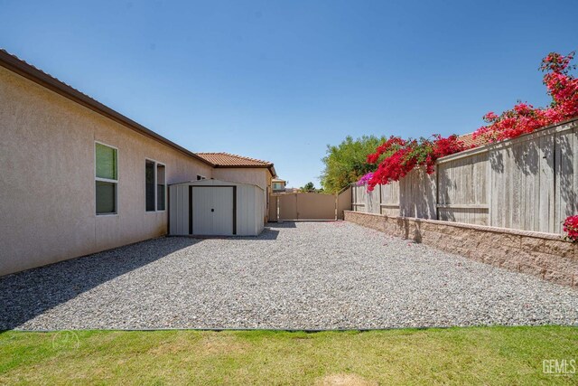 6315 Veronese Ct, Bakersfield, CA 93306 - fenced backyard with a storage unit and a patio area