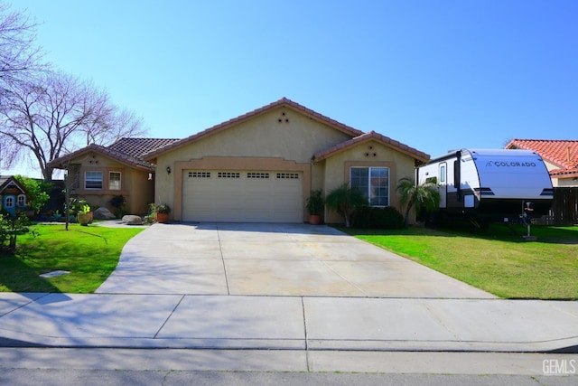 mediterranean / spanish home with an attached garage, a front lawn, concrete driveway, and stucco siding