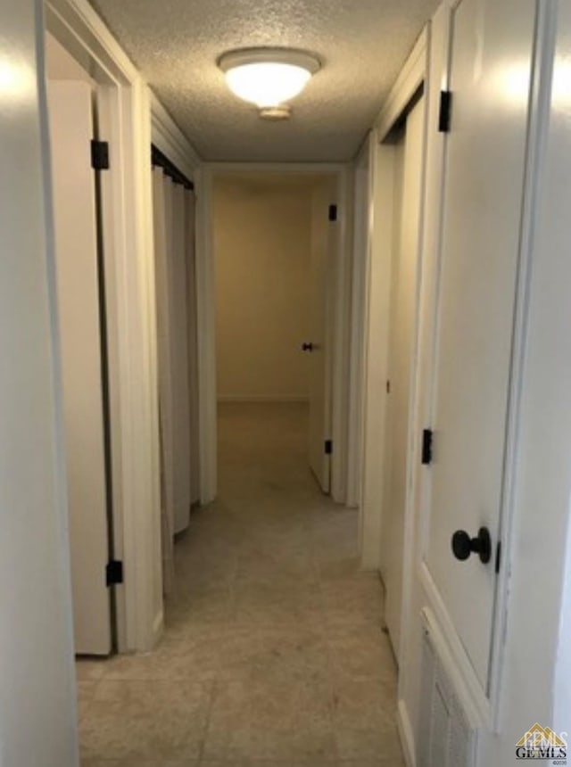 2912 Lum Ave, Bakersfield, CA 93304 - hallway featuring a textured ceiling