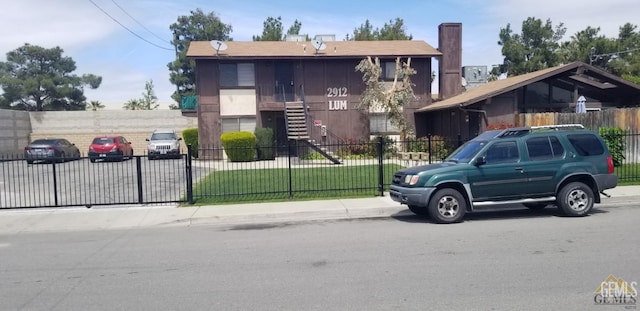 2912 Lum Ave, Bakersfield, CA 93304 - view of front facade with a fenced front yard, stairs, a chimney, and a gate