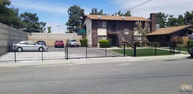 2912 Lum Ave, Bakersfield, CA 93304 - view of front of home with a fenced front yard and stairs