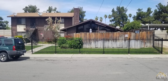 2912 Lum Ave, Bakersfield, CA 93304 - view of front facade featuring a fenced front yard, stairs, and a chimney