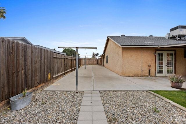 view of home's exterior with a fenced backyard, a patio area, stucco siding, and french doors