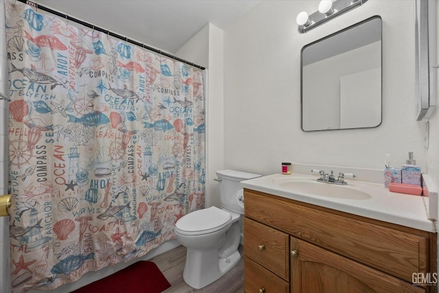 full bathroom featuring vanity, a shower with curtain, toilet, and wood finished floors