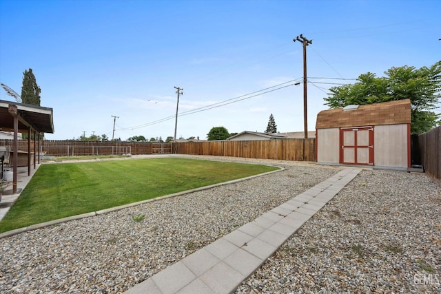 view of yard featuring a fenced backyard, an outbuilding, and a shed