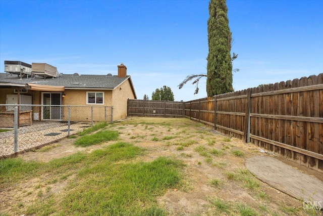 view of yard with a fenced backyard