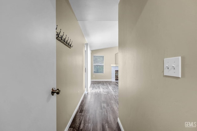 hallway with baseboards and wood finished floors