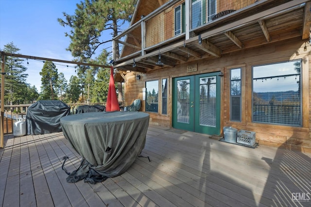 wooden deck featuring grilling area and french doors