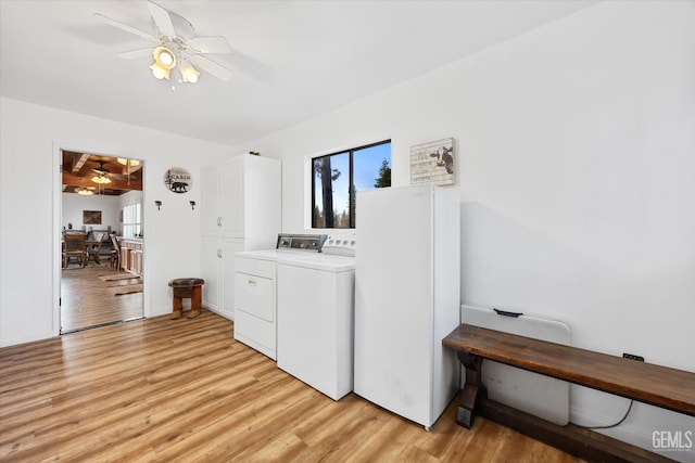 laundry area with ceiling fan, laundry area, light wood finished floors, and washer and clothes dryer