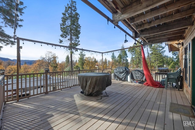 wooden deck featuring a grill