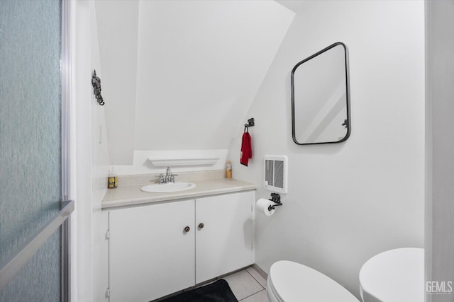 half bath featuring toilet, tile patterned floors, and vanity