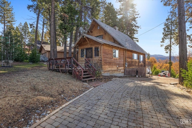 view of side of home with crawl space and a wooden deck