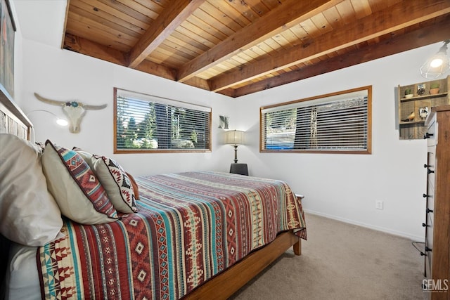 carpeted bedroom with wooden ceiling, beam ceiling, and baseboards