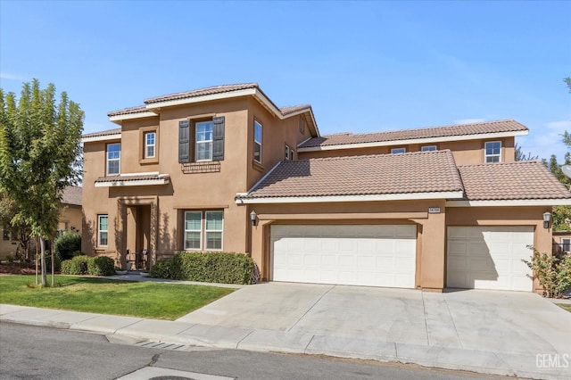 mediterranean / spanish-style home with a front yard and a garage