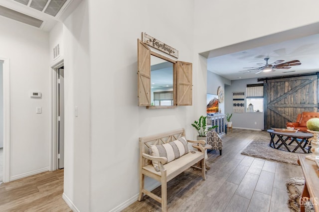 corridor featuring baseboards and light wood-style flooring