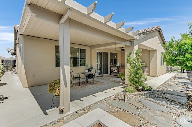 back of property with a patio area and stucco siding
