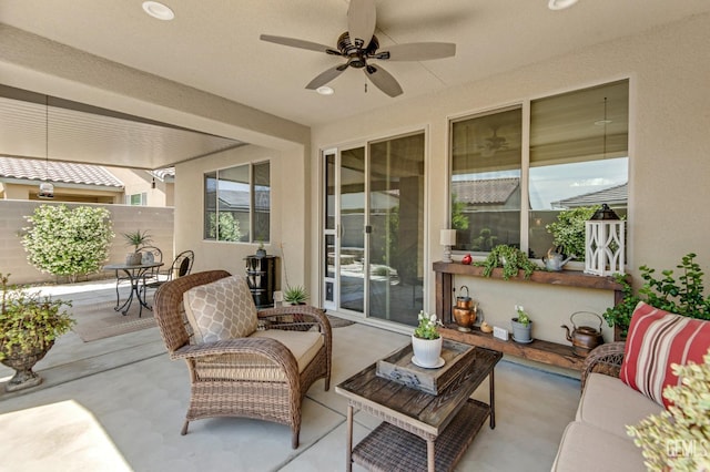 view of patio featuring a ceiling fan and fence
