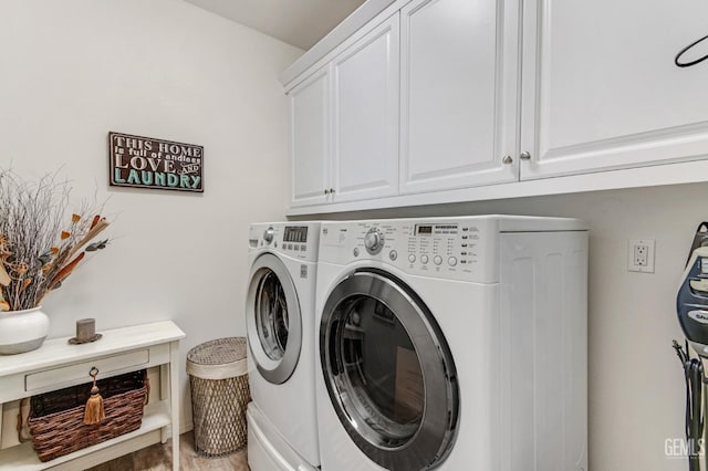 laundry area featuring independent washer and dryer and cabinet space