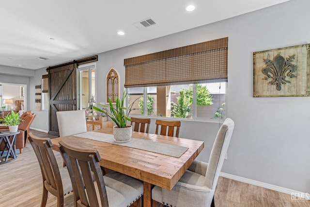 dining room with a barn door, recessed lighting, baseboards, light wood-type flooring, and visible vents