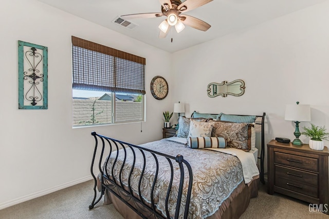 carpeted bedroom with baseboards, a ceiling fan, and visible vents