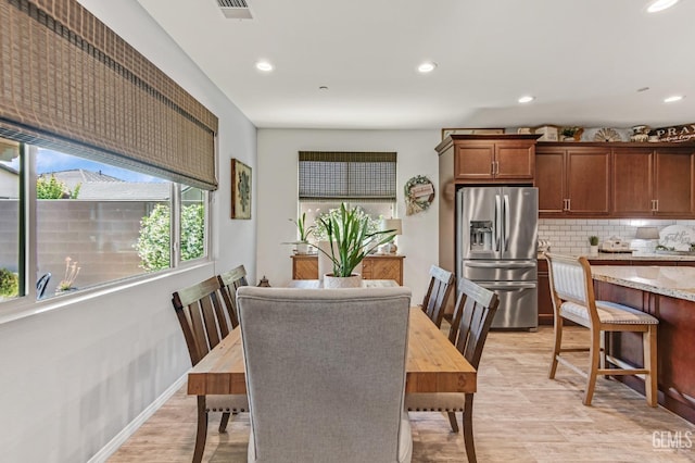 dining room featuring recessed lighting, light wood-style flooring, and visible vents