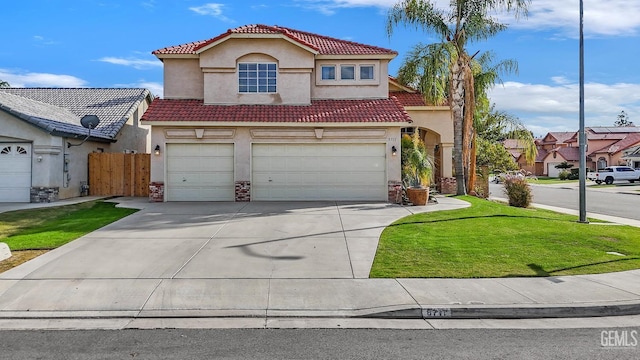 mediterranean / spanish home with a front lawn and a garage