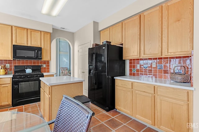 kitchen with black appliances, decorative backsplash, light brown cabinets, and a center island