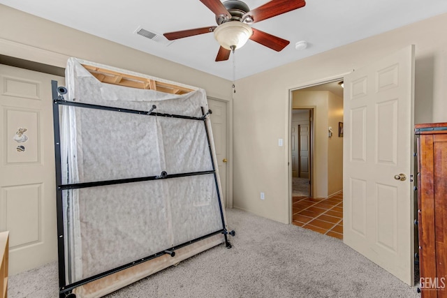 unfurnished bedroom featuring ceiling fan and light carpet