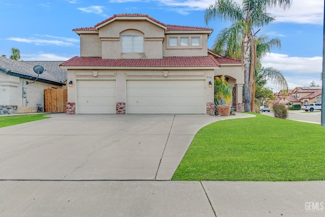 mediterranean / spanish-style home with a front yard and a garage