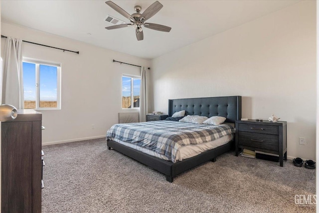 carpeted bedroom with ceiling fan and multiple windows