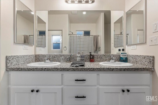 bathroom featuring a shower with curtain and vanity